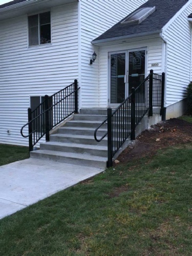 New steps poured with heating elements for winter snow and ice and Fortress power coated metal guard rail.